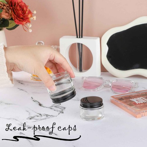 RAMFIYN 24 Pack 2oz Clear Glass Jars Small Glass Containers with Black Metal Lids Empty Cosmetic Jars with Inner Liners and Lids Clear Glass Lotion Jars with Labels for Traveling